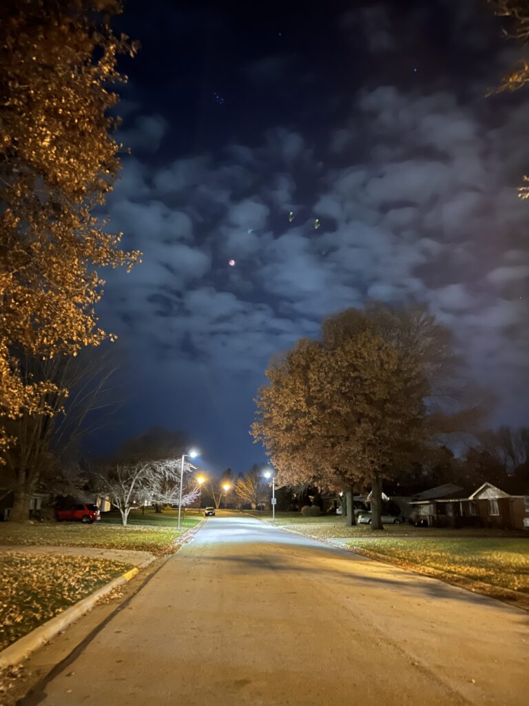 Photo of the total lunar eclipse in a partially cloudy sky taken early in the morning from the middle of the street
